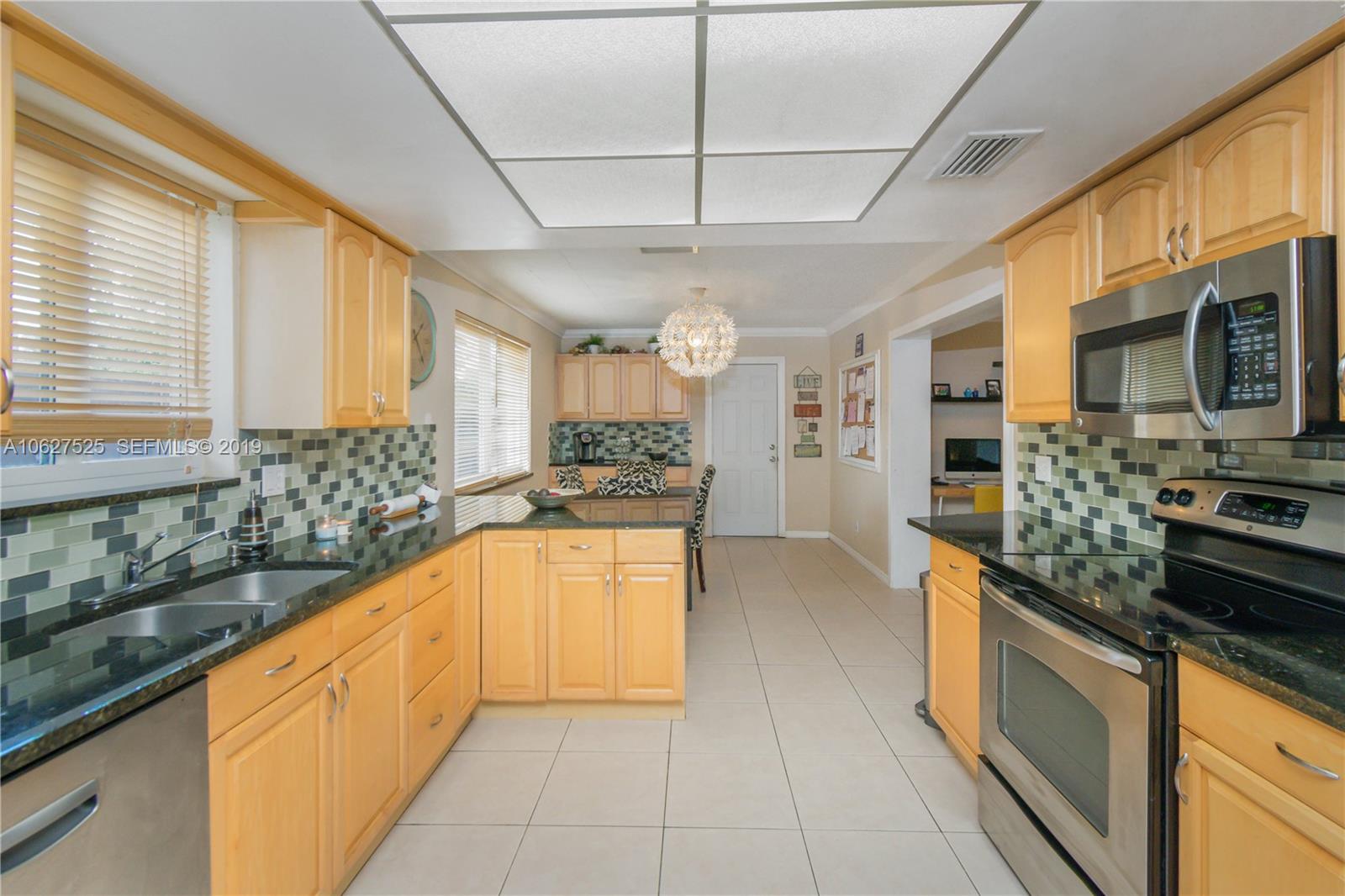 3339 West Park Road Hollywood, FL 33021 - Photo 9 of 28 a large kitchen with stainless steel appliances granite countertop a stove and a sink