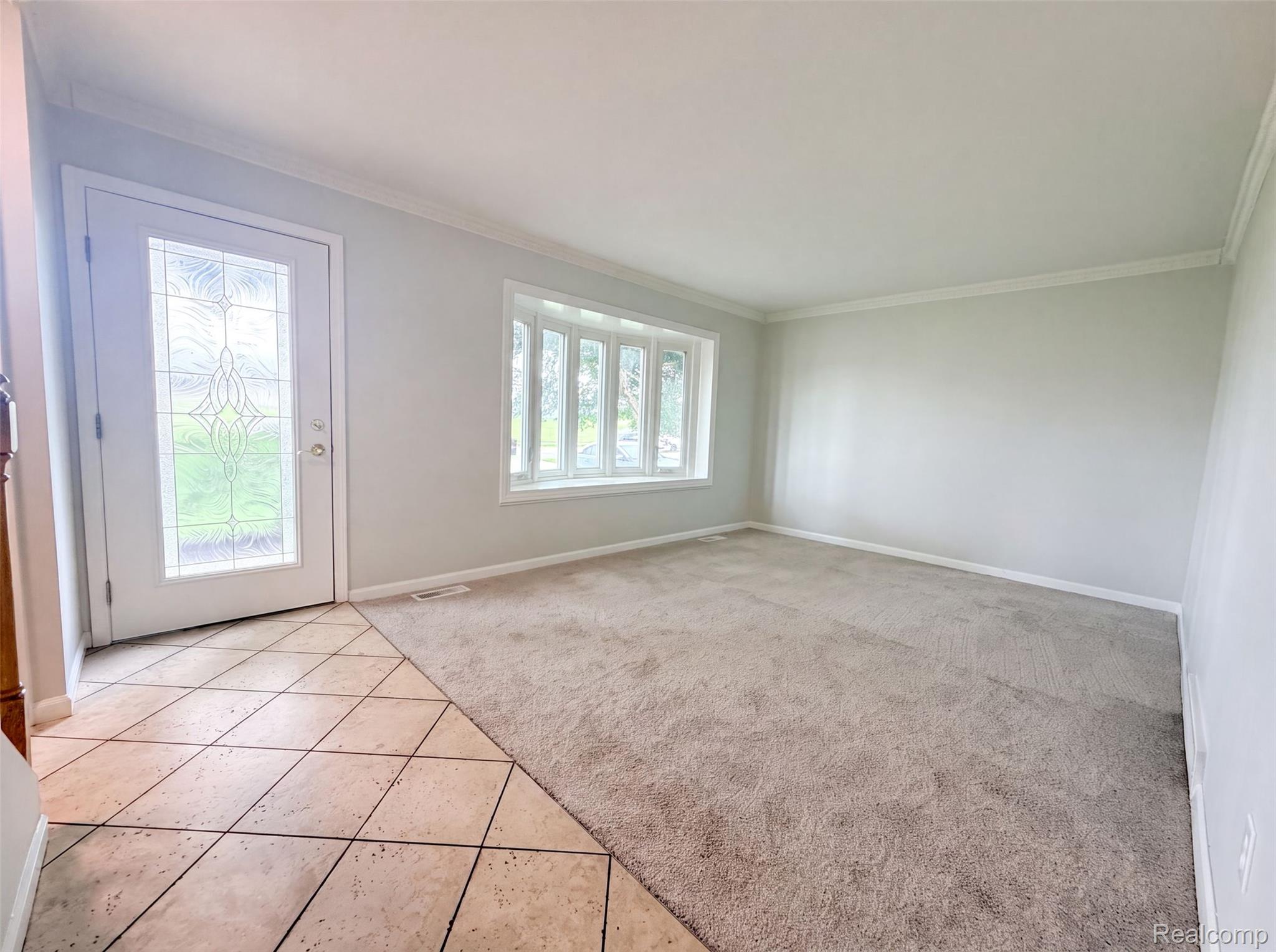 14729 Moran Road Allen Park, MI 48101 - Photo 8 of 17 Inviting entry space featuring a decorative glass panel door, light-toned tile flooring, and a multi-pane bay window