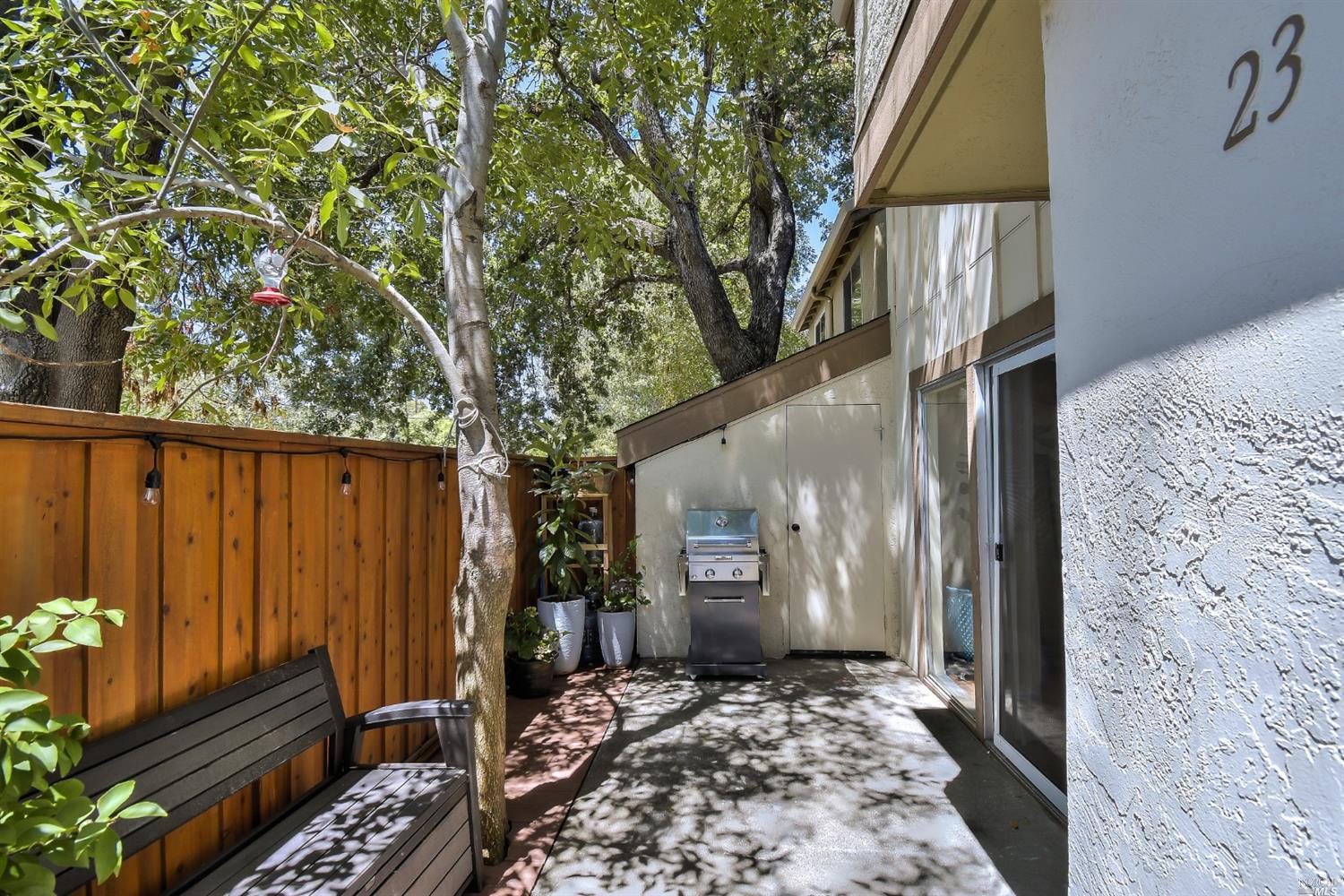 1548 Center Road, Unit 23 Novato, CA 94947 - Photo 1 of 1 a backyard of a house with barbeque oven table and chairs