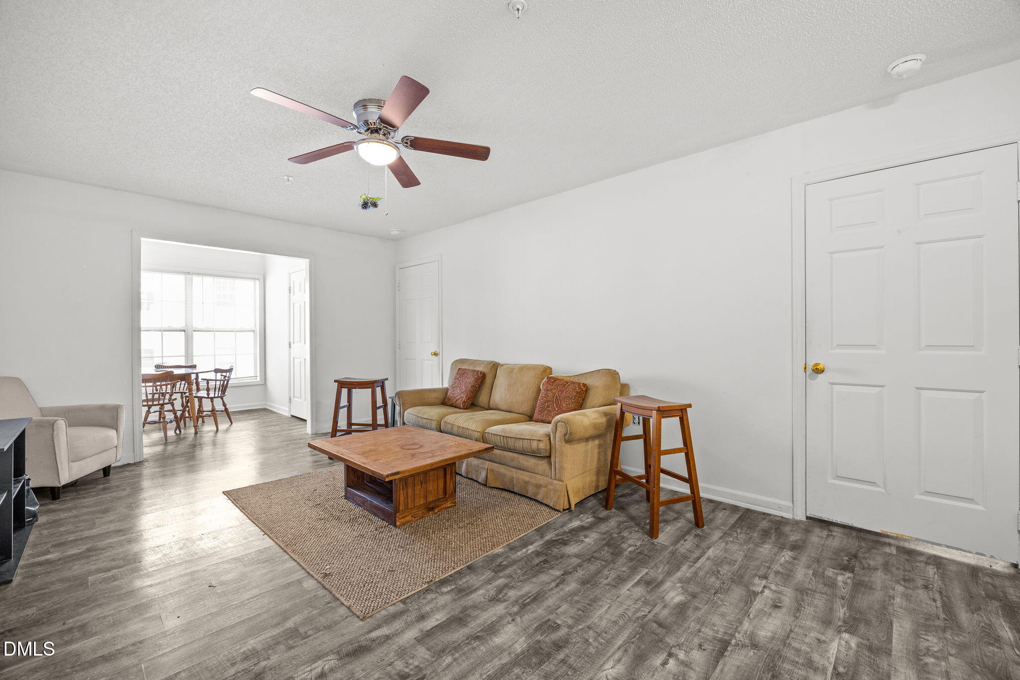 1305 Kent Road, Unit 101 Raleigh, NC 27606 - Photo 5 of 29 a living room with furniture and wooden floor