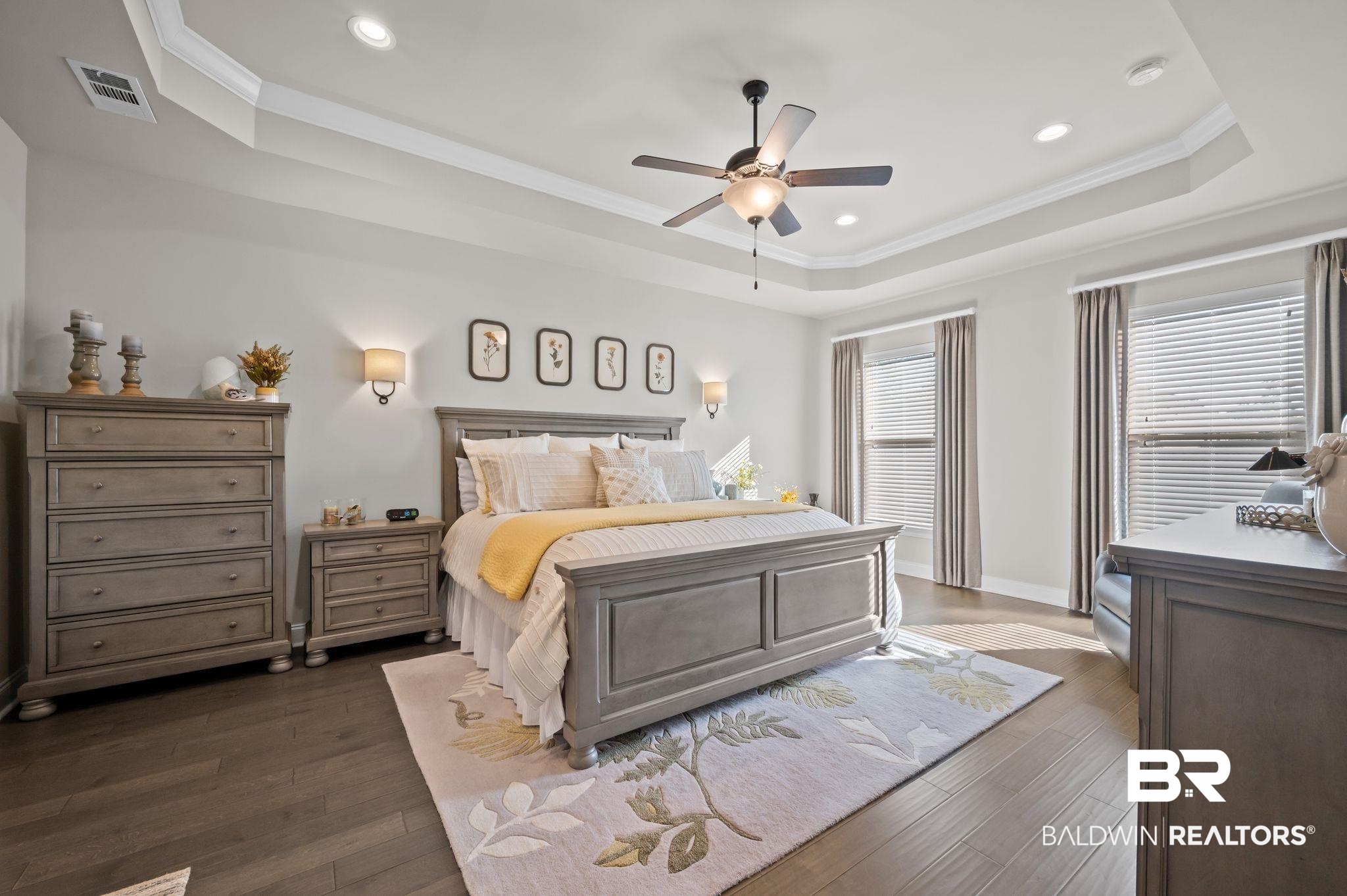 33842 Rutland Lane Spanish Fort, AL 36527 - Photo 18 of 42 Bedroom featuring crown molding, a tray ceiling, visible vents, and dark wood-style floors