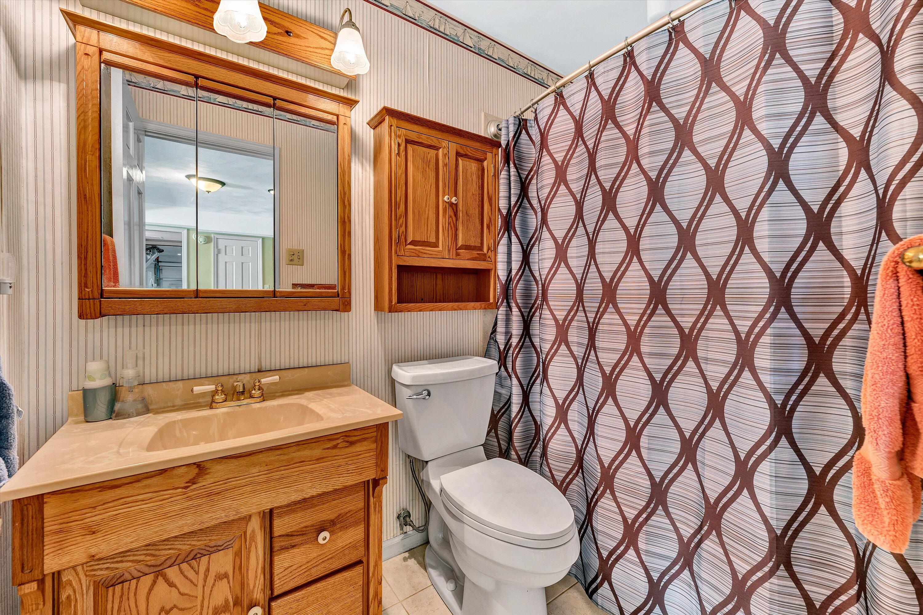 2921 Lockridge Road Southwest Roanoke, VA 24014 - Photo 33 of 53 a bathroom with a granite countertop sink and a toilet