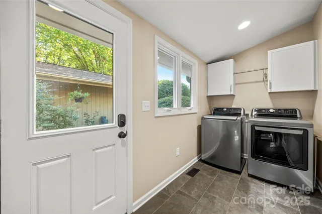a kitchen with a stove a sink and a window
