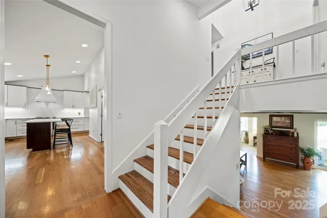 a view of entryway and hall with wooden floor