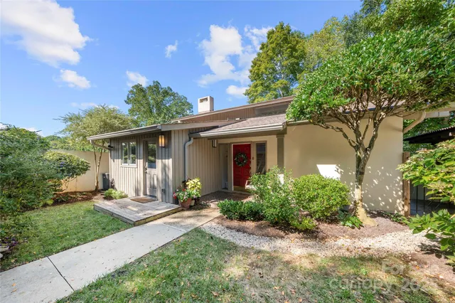 a front view of a house with a yard and outdoor seating