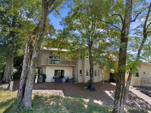 a view of a house with a tree in the yard