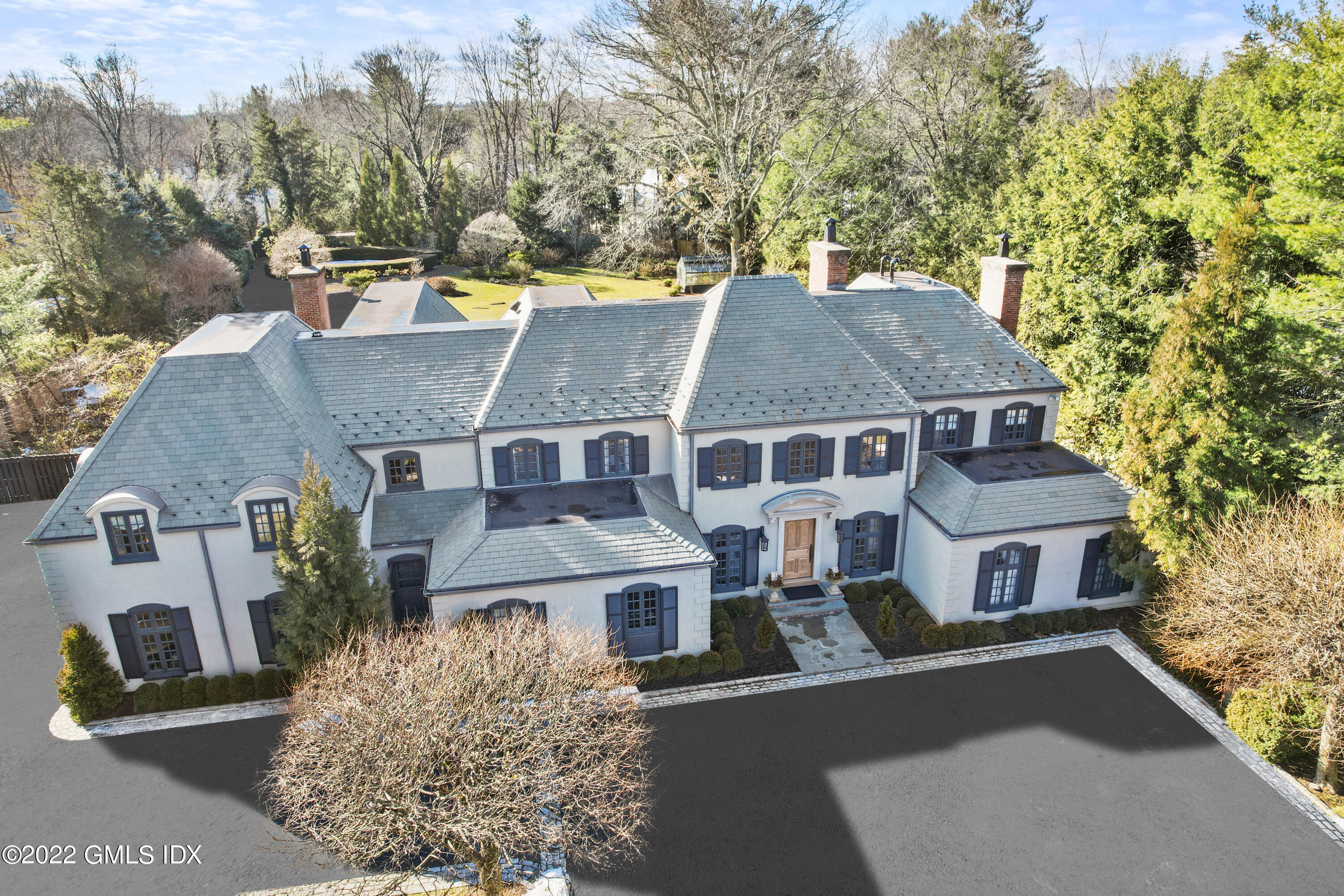 aerial view of a house with a yard and large tree