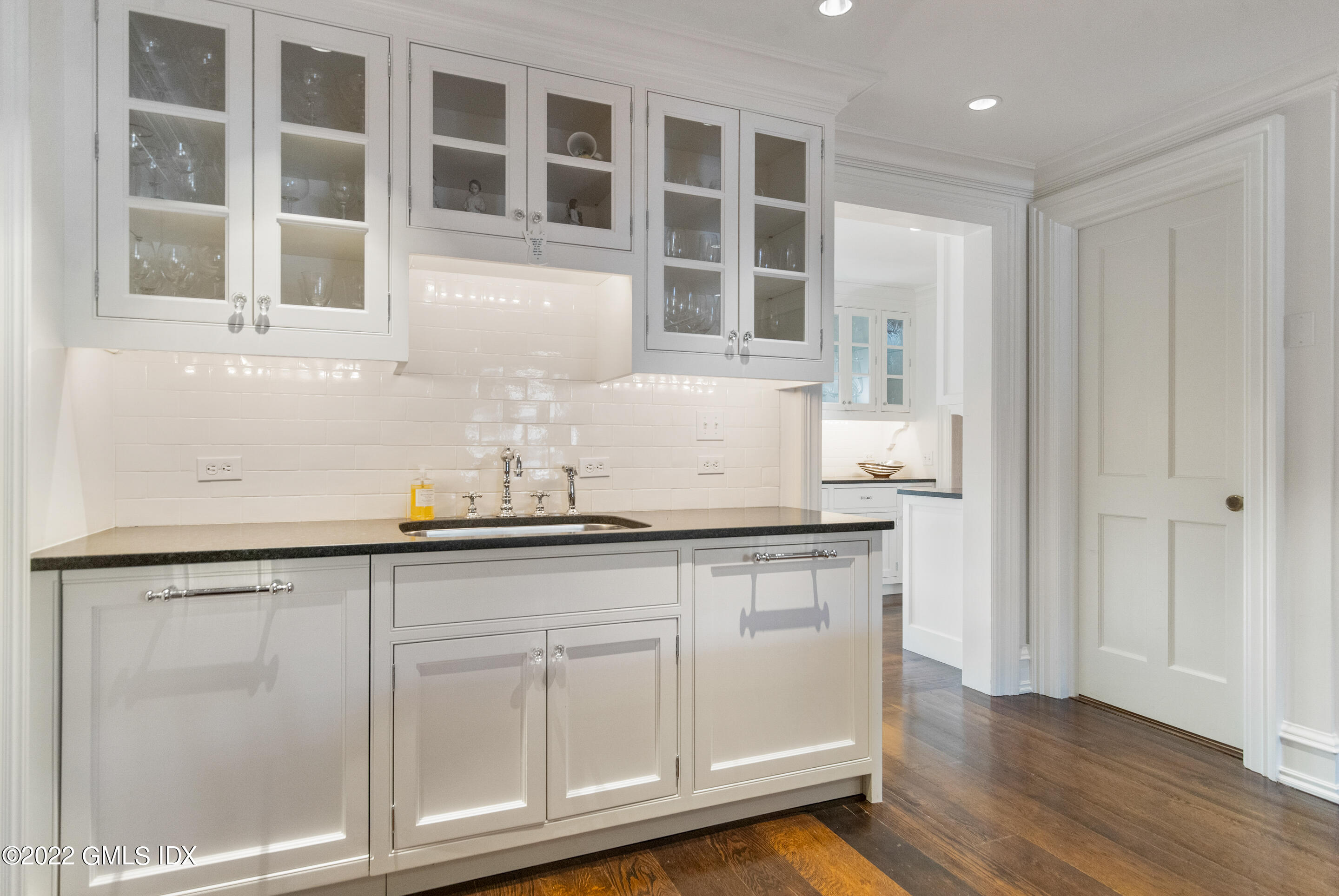 266 Round Hill Road Greenwich, CT 06831 - Photo 12 of 27 a kitchen with granite countertop white cabinets and sink