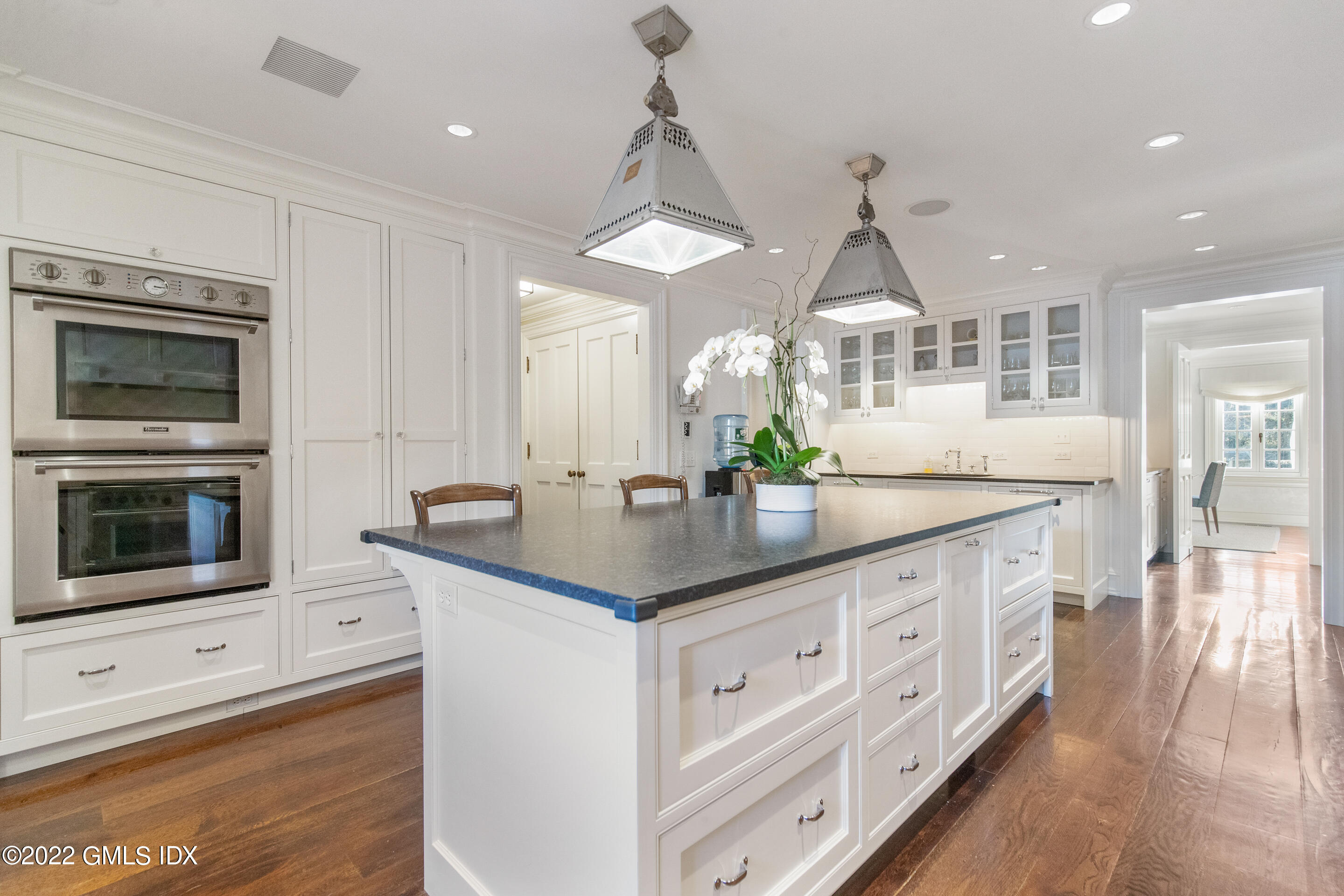266 Round Hill Road Greenwich, CT 06831 - Photo 13 of 27 a kitchen with stainless steel appliances kitchen island granite countertop a sink a stove and a wooden floors