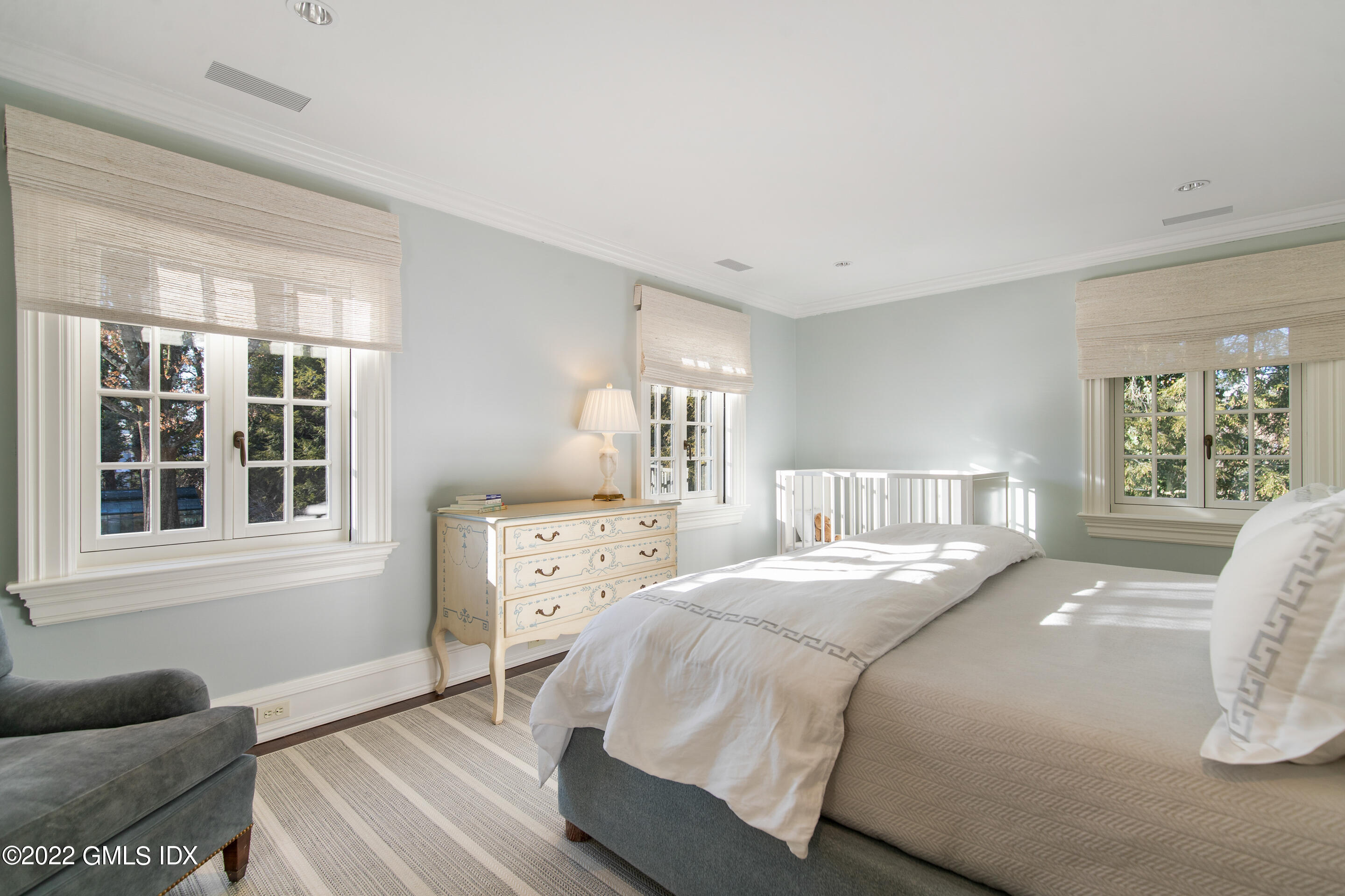 266 Round Hill Road Greenwich, CT 06831 - Photo 21 of 27 a bedroom with a bed and wooden floor