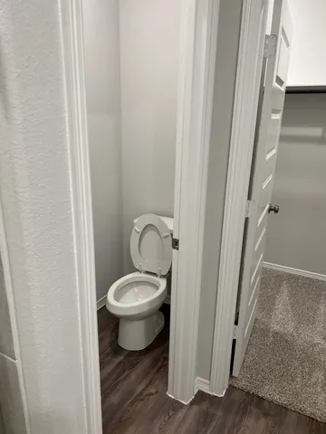 a white toilet sitting next to a sink