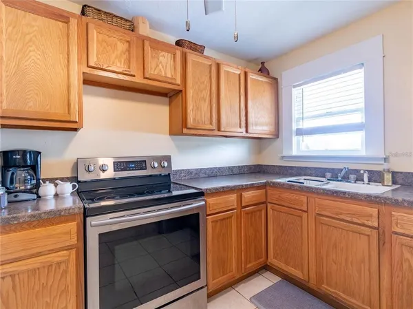 a kitchen with granite countertop cabinets stainless steel appliances and a sink