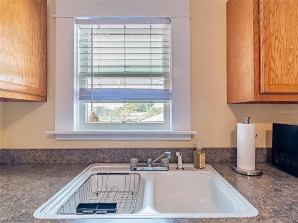 a bathroom with a sink a bathtub and next to a window