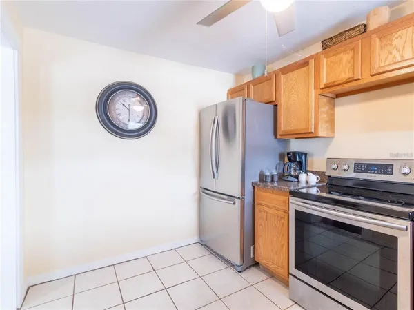a kitchen with a refrigerator and a stove top oven