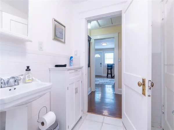 a bathroom with a sink a toilet and mirror