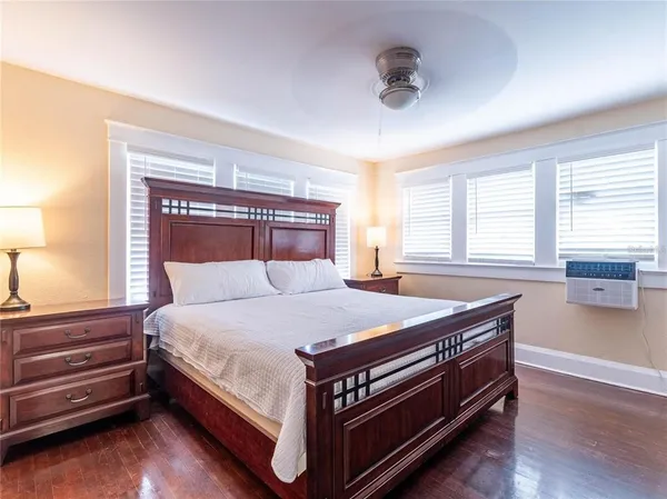 a bed sitting in a bedroom next to a window