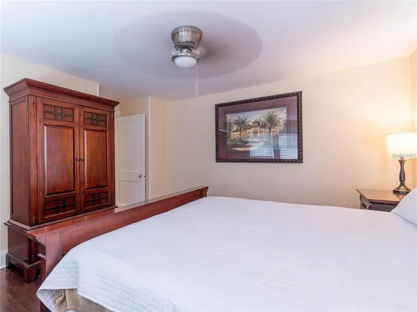 a bedroom with a large bed and a chandelier