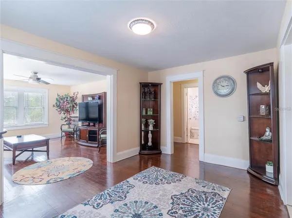 a living room with furniture and wooden floor