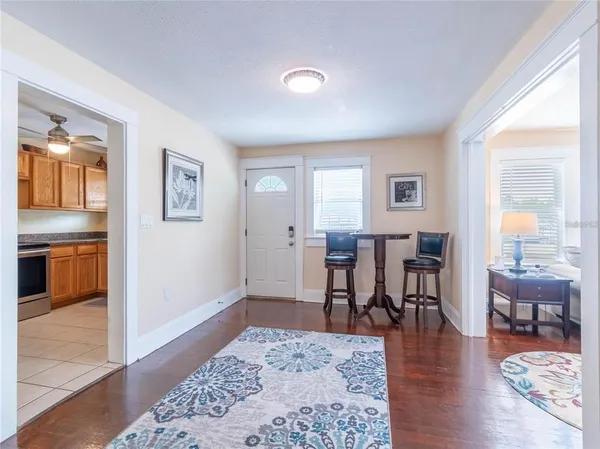 a view of a a dining room with furniture window and wooden floor