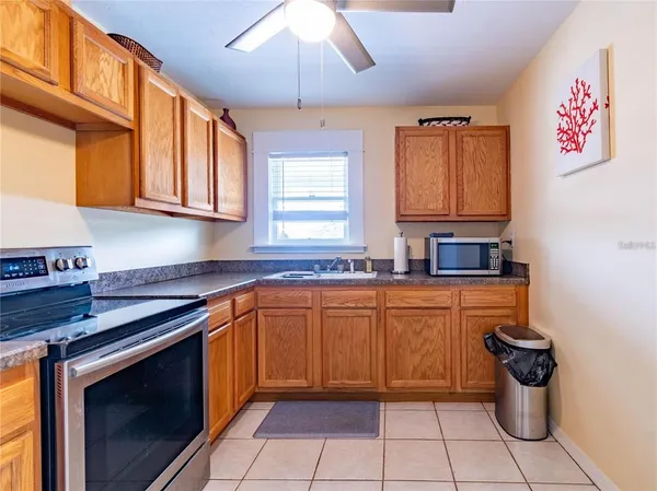 a kitchen with stainless steel appliances granite countertop a sink and a stove