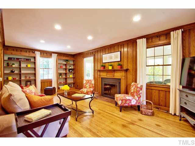 128 Pinecrest Road Durham, NC 27705 - Photo 4 of 18 Warm wood floors and solid pine paneling make this space feel cozy. Bookcases are not built in, so feel free to move them out if you prefer. Living Room