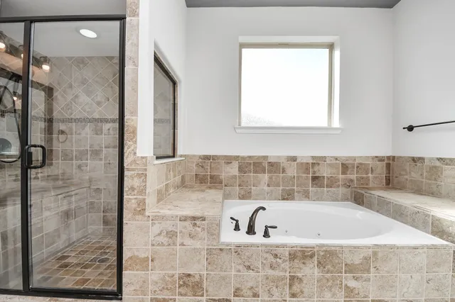 a bathroom with a bathtub and shower