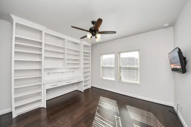 a view of a livingroom with a hardwood floor and a ceiling fan