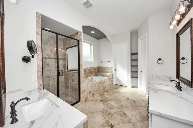 a bathroom with a tub sink and shower