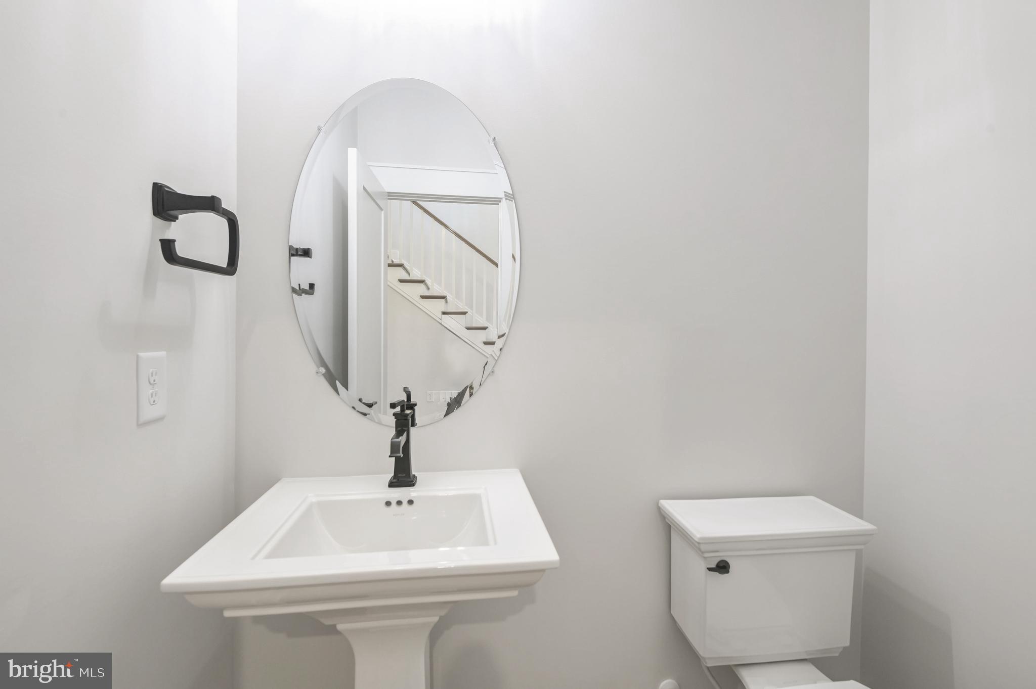 11310 Eliana Court Laurel, MD 20708 - Photo 17 of 48 a bathroom with a toilet sink and mirror