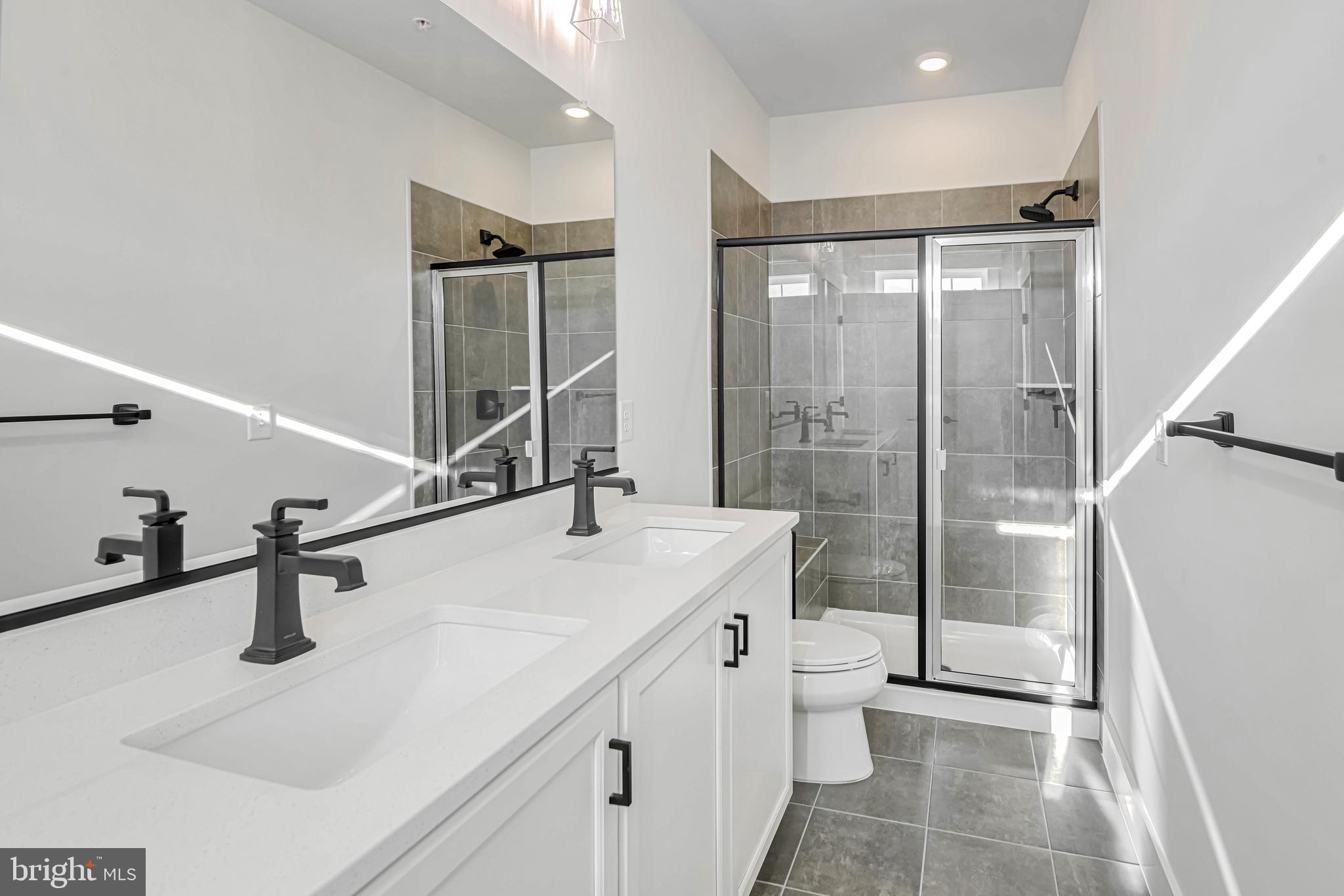 11310 Eliana Court Laurel, MD 20708 - Photo 36 of 48 a bathroom with a sink a toilet and shower