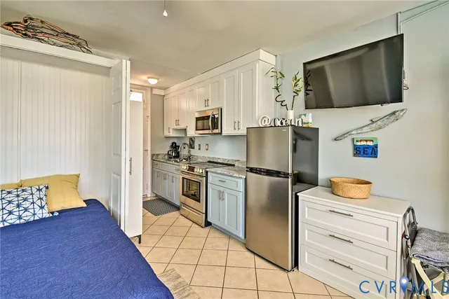 a kitchen with stainless steel appliances a refrigerator stove and microwave