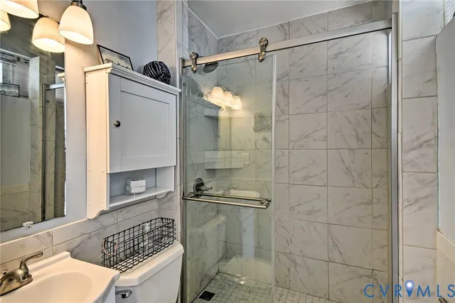 a bathroom with a shower and a sink