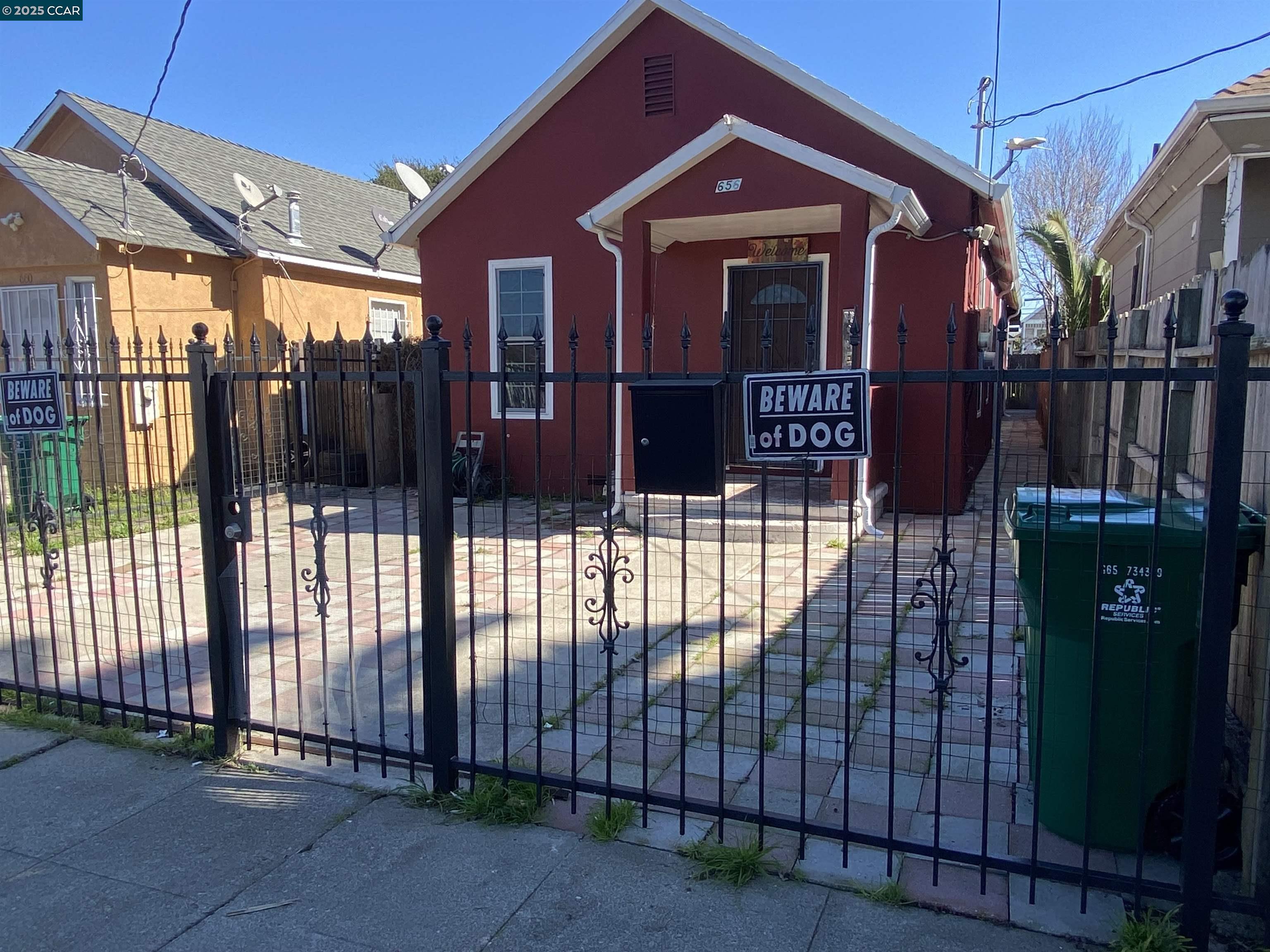 a view of a house with wooden fence