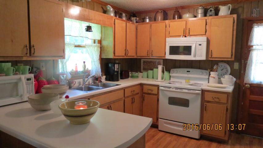 475 Mail Road Erin, TN 37061 - Photo 11 of 21 a kitchen with a sink a stove and cabinets