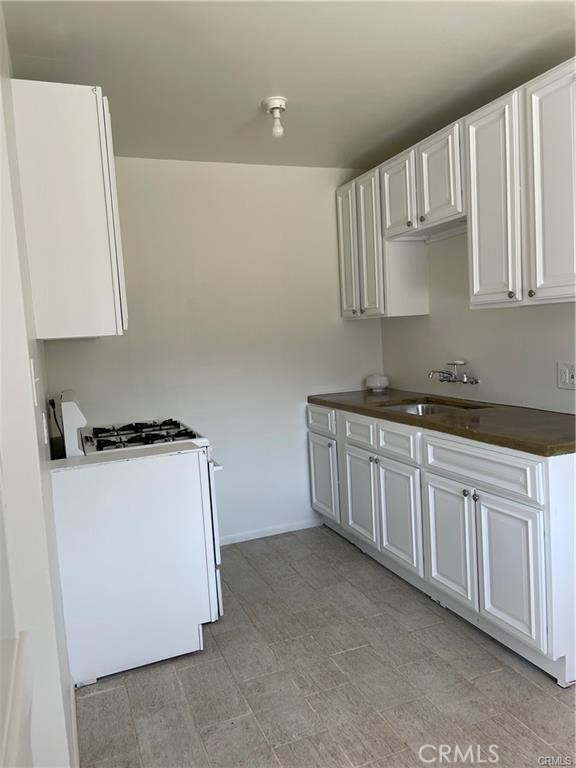 2738 Southern, Unit B South Gate, CA 90280 - Photo 3 of 19 a kitchen with white cabinets