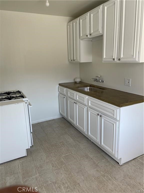 2738 Southern, Unit B South Gate, CA 90280 - Photo 4 of 19 a kitchen with granite countertop white cabinets and white appliances