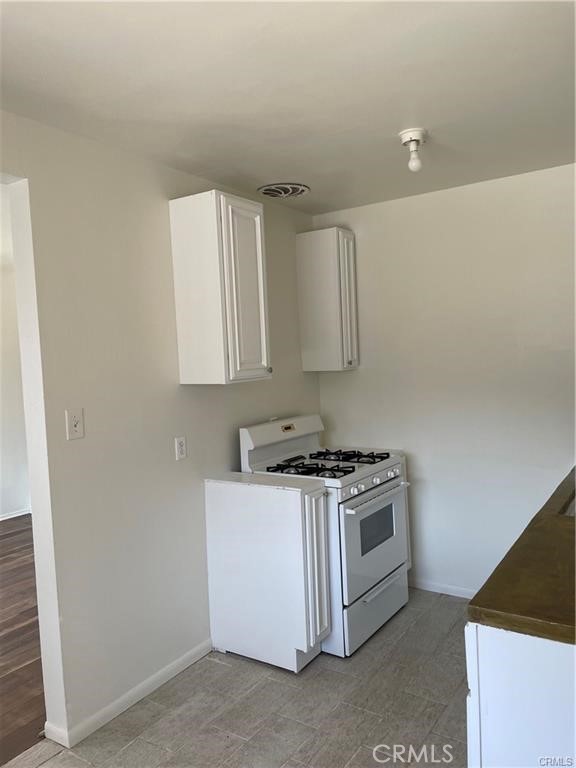2738 Southern, Unit B South Gate, CA 90280 - Photo 5 of 19 a kitchen with white cabinets and white appliances