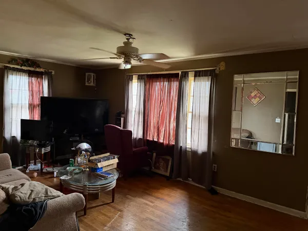 a living room with furniture a window and a chandelier