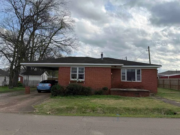 a view of the house with a yard