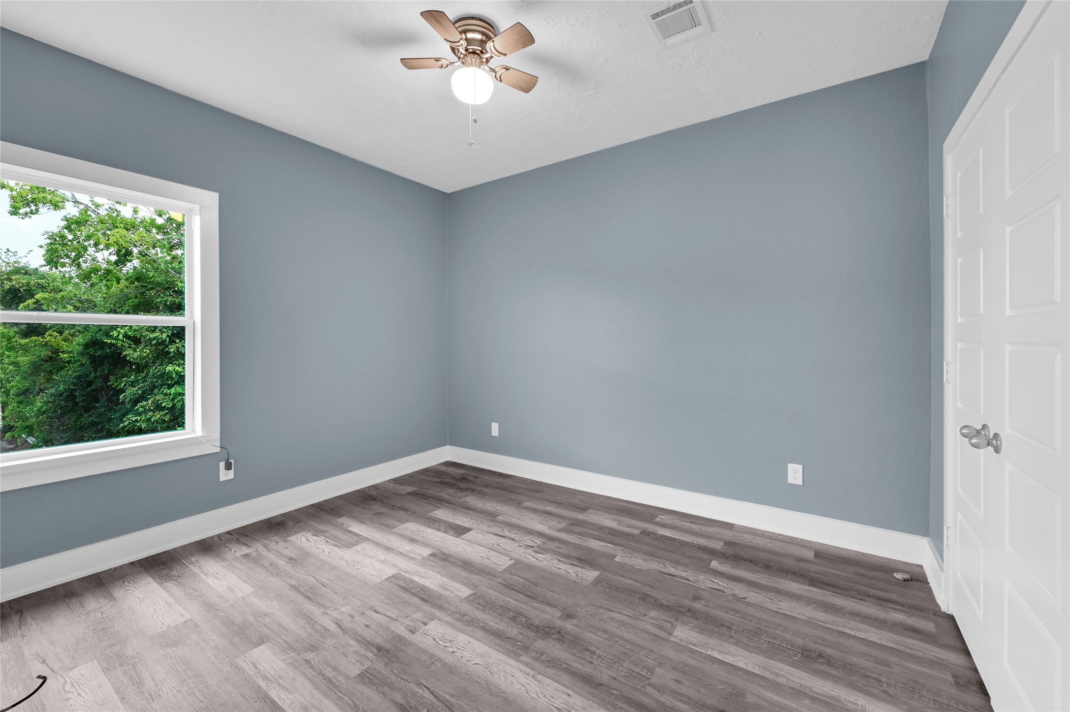 4304 New Orleans Street Houston, TX 77020 - Photo 18 of 23 a view of an empty room with wooden floor and a window