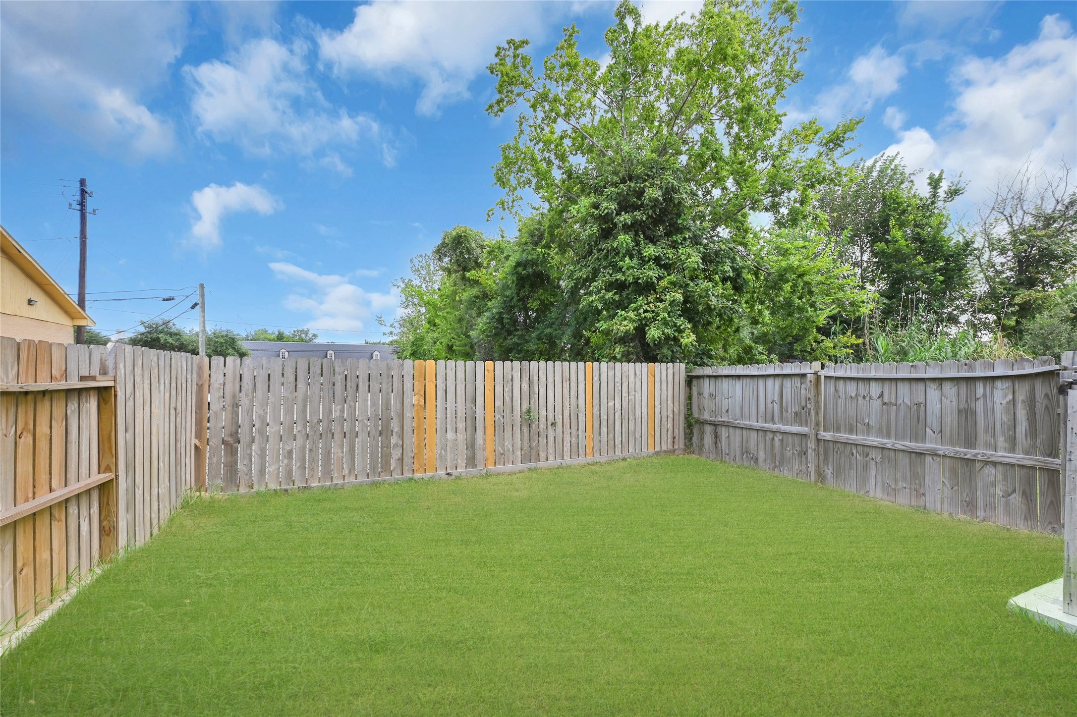 4304 New Orleans Street Houston, TX 77020 - Photo 20 of 23 a view of backyard with wooden fence and trees