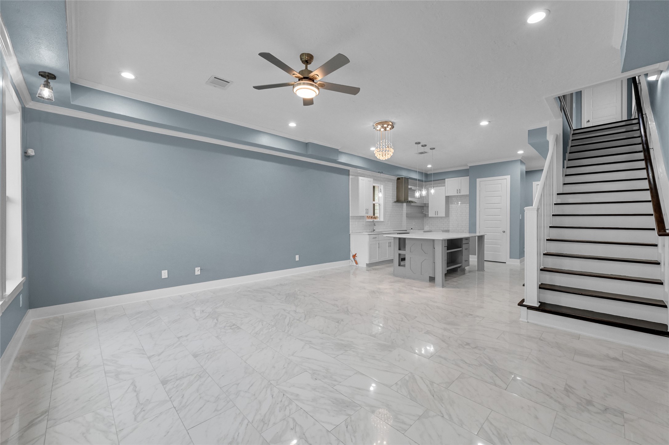 4304 New Orleans Street Houston, TX 77020 - Photo 8 of 23 wooden floor with white walls and chandelier fan