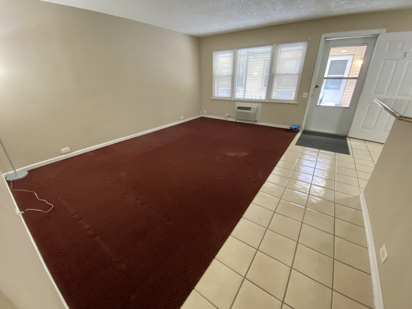 4041 South Harlem Avenue, Unit 3 Stickney, IL 60402 - Photo 3 of 12 an empty room with wooden floor and windows