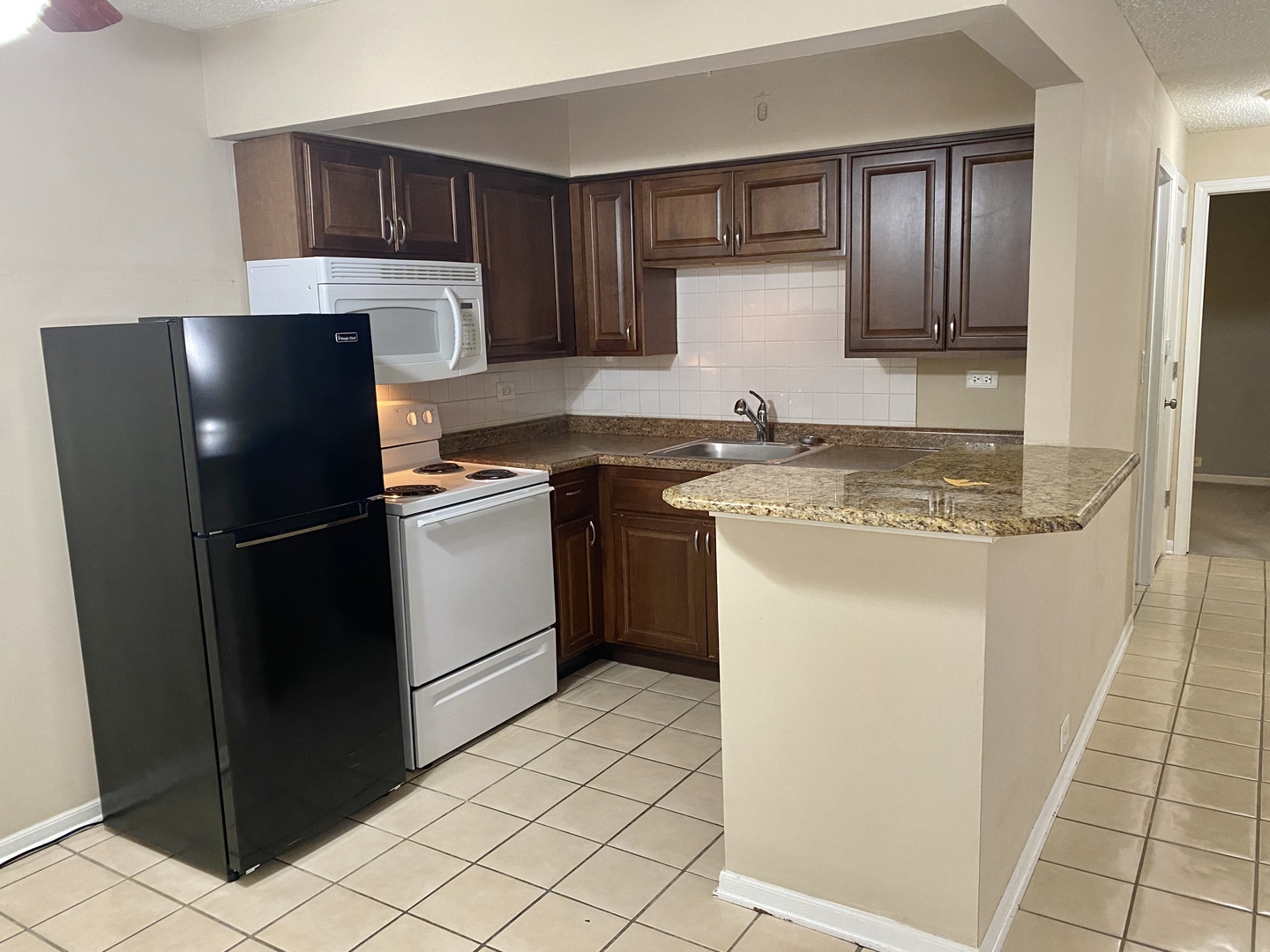 4041 South Harlem Avenue, Unit 3 Stickney, IL 60402 - Photo 5 of 12 a kitchen with a refrigerator sink stove and cabinets