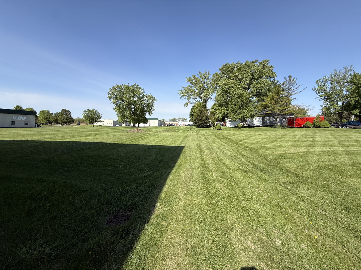 25501 West Wolfs Road Plainfield, IL 60585 - Photo 7 of 22 a yard with lots of green space and trees in the background