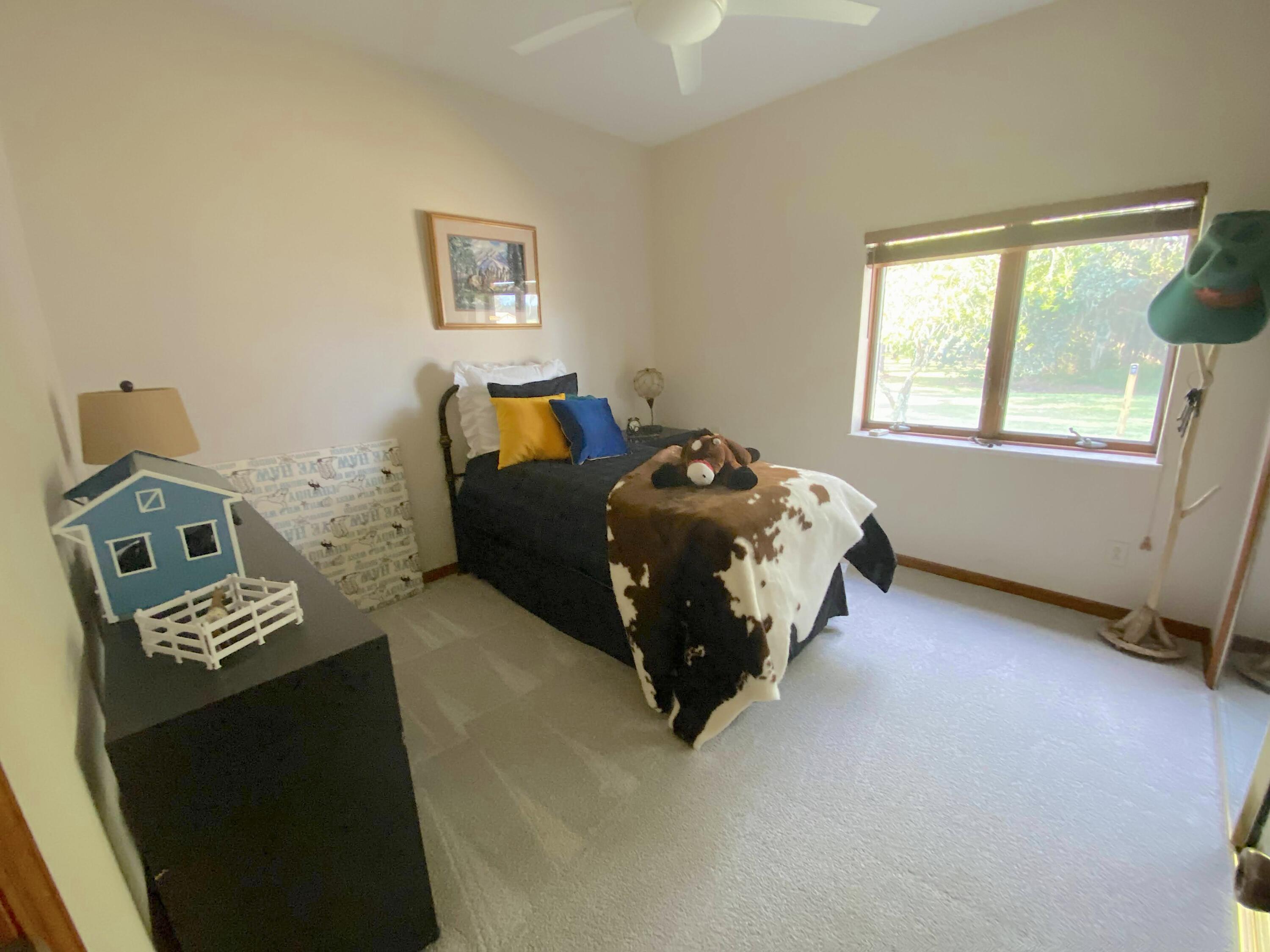 3046 North Bowden Road Avon Park, FL 33825 - Photo 17 of 41 a bed sitting in a bedroom next to a window