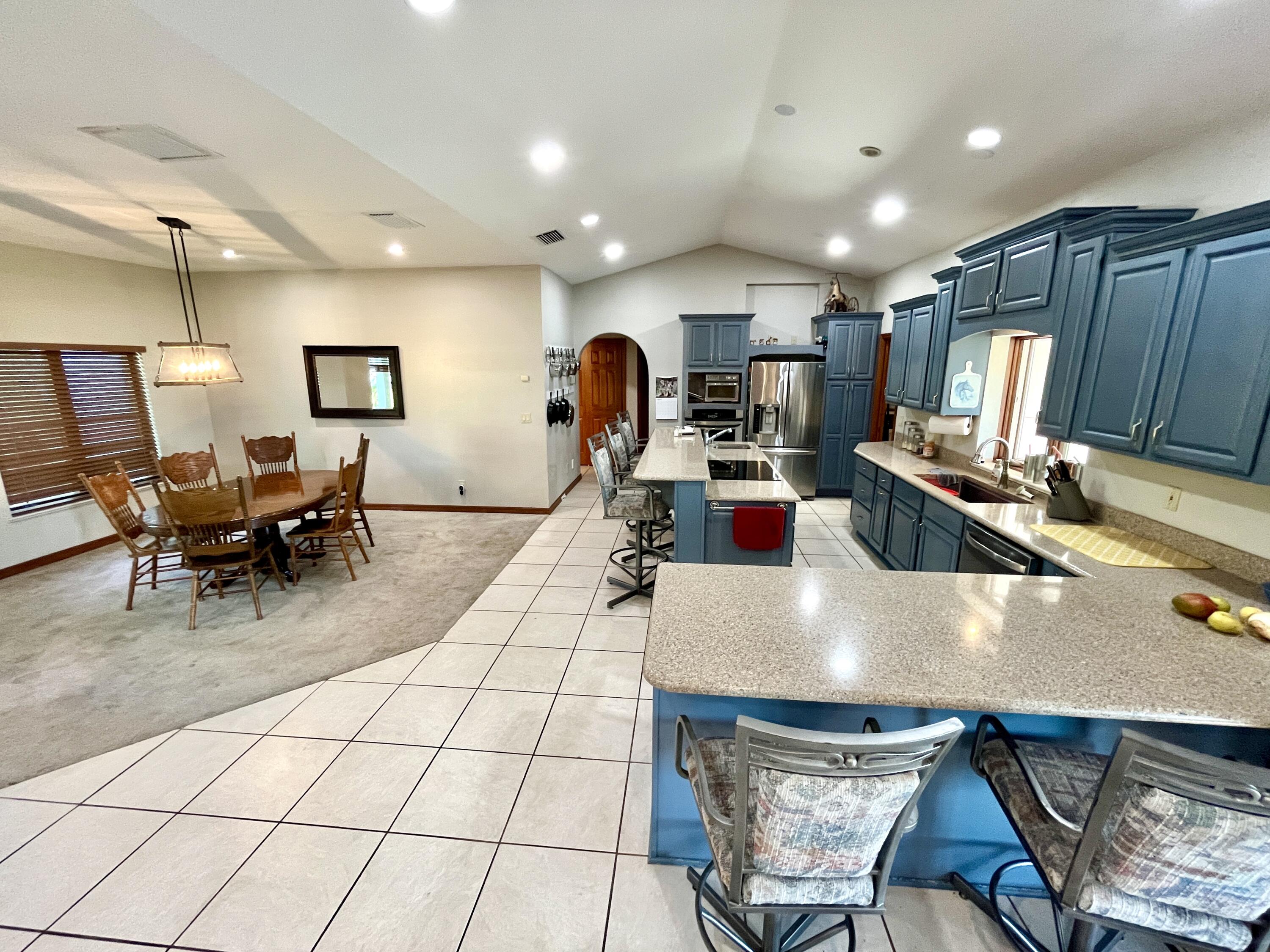 3046 North Bowden Road Avon Park, FL 33825 - Photo 8 of 41 a living room with couches a computer on a table and kitchen countertops with wooden floor