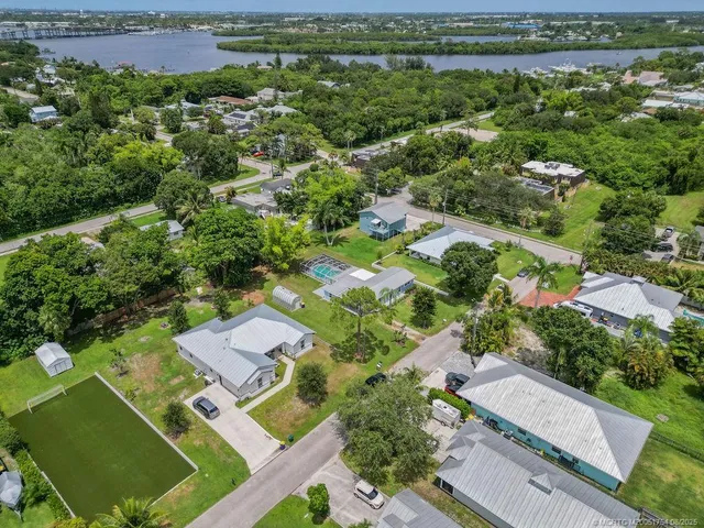 an aerial view of a residential houses with outdoor space and street view