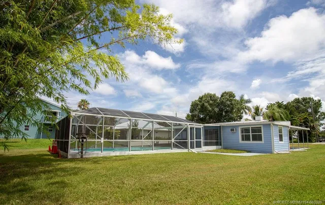 a view of a house with a backyard