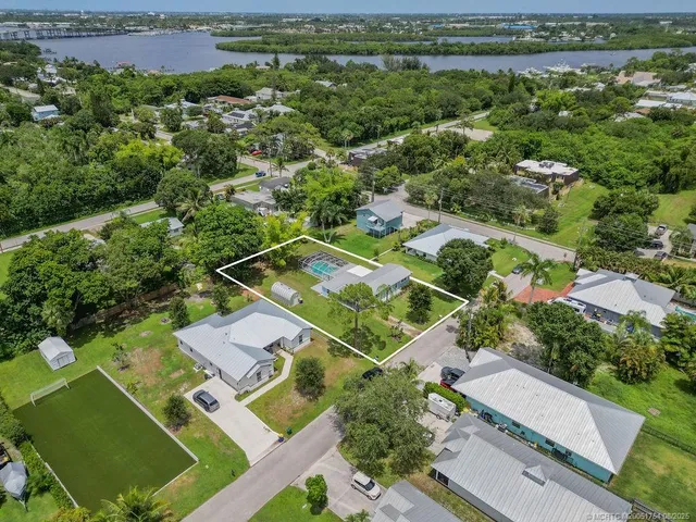 an aerial view of a house with a yard